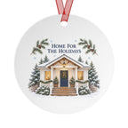 Back view of a round aluminum ornament with winter house artwork.